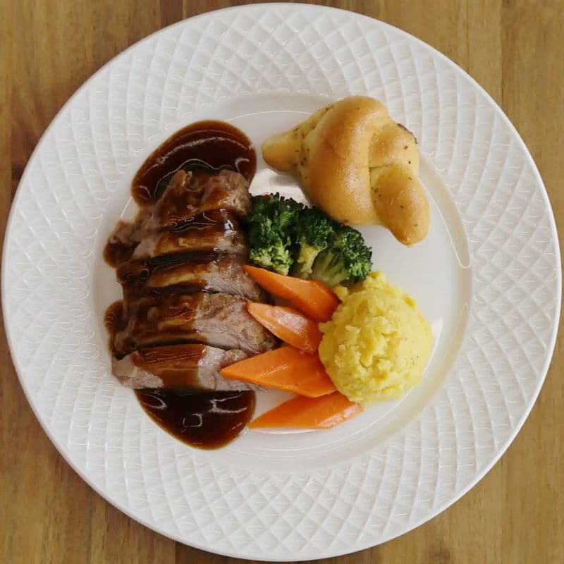 Slow Cooked Lamb Shoulder, White Cheddar Polenta, Sautéed Vegetables Gravy