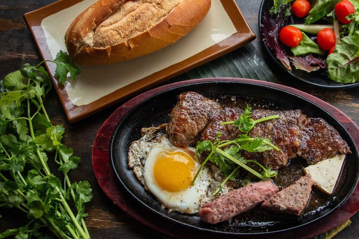 S09. Vietnamese Style Steak with Fried Egg, Pate, Grilled Pork Sausage, Salad & Banh Mi