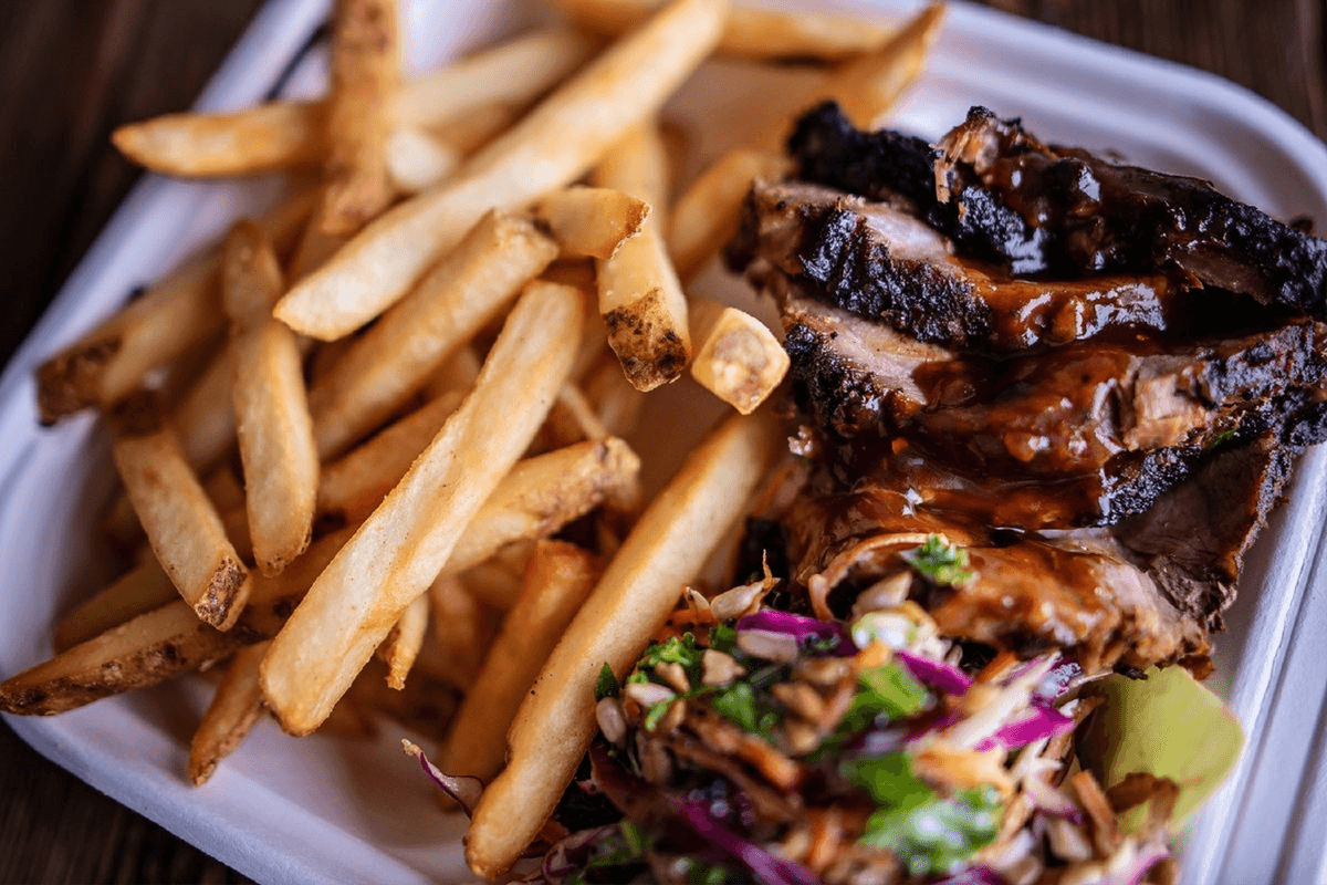 Jerk Chicken and Jerk Pork Mixed with Fries and Kale Slaw - Big Appetite