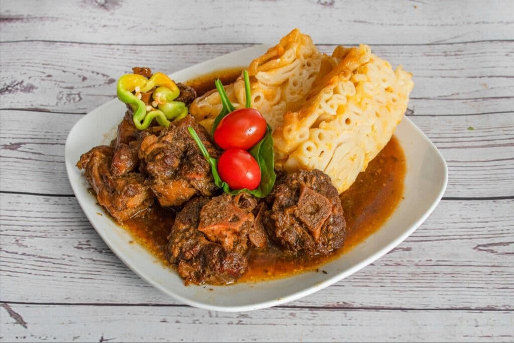 Oxtail with Macaroni Pie, Plantain, and Coleslaw