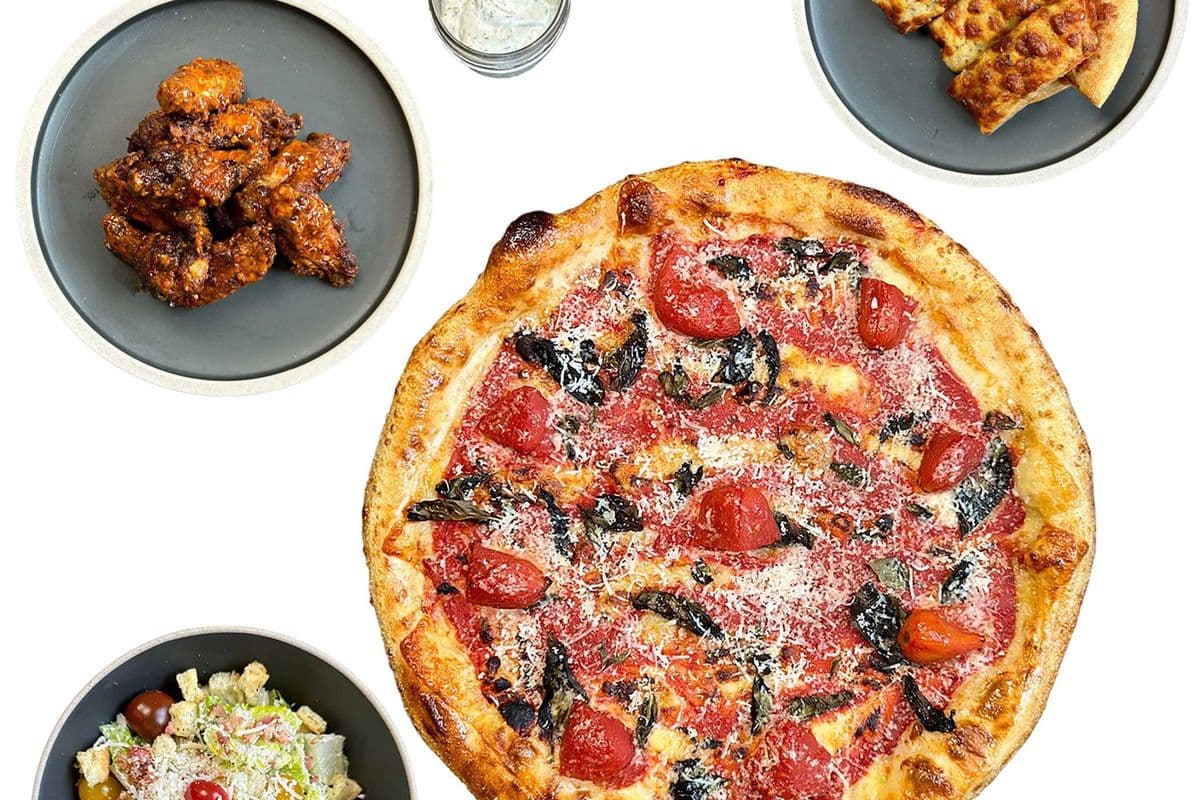 Bundle for 4-6: one 16" NYC Pizza, 9 Spiced Chicken Wings, CHAR Caesar Salad, Garlic and Cheese Bread Sticks, a Crusty Dip