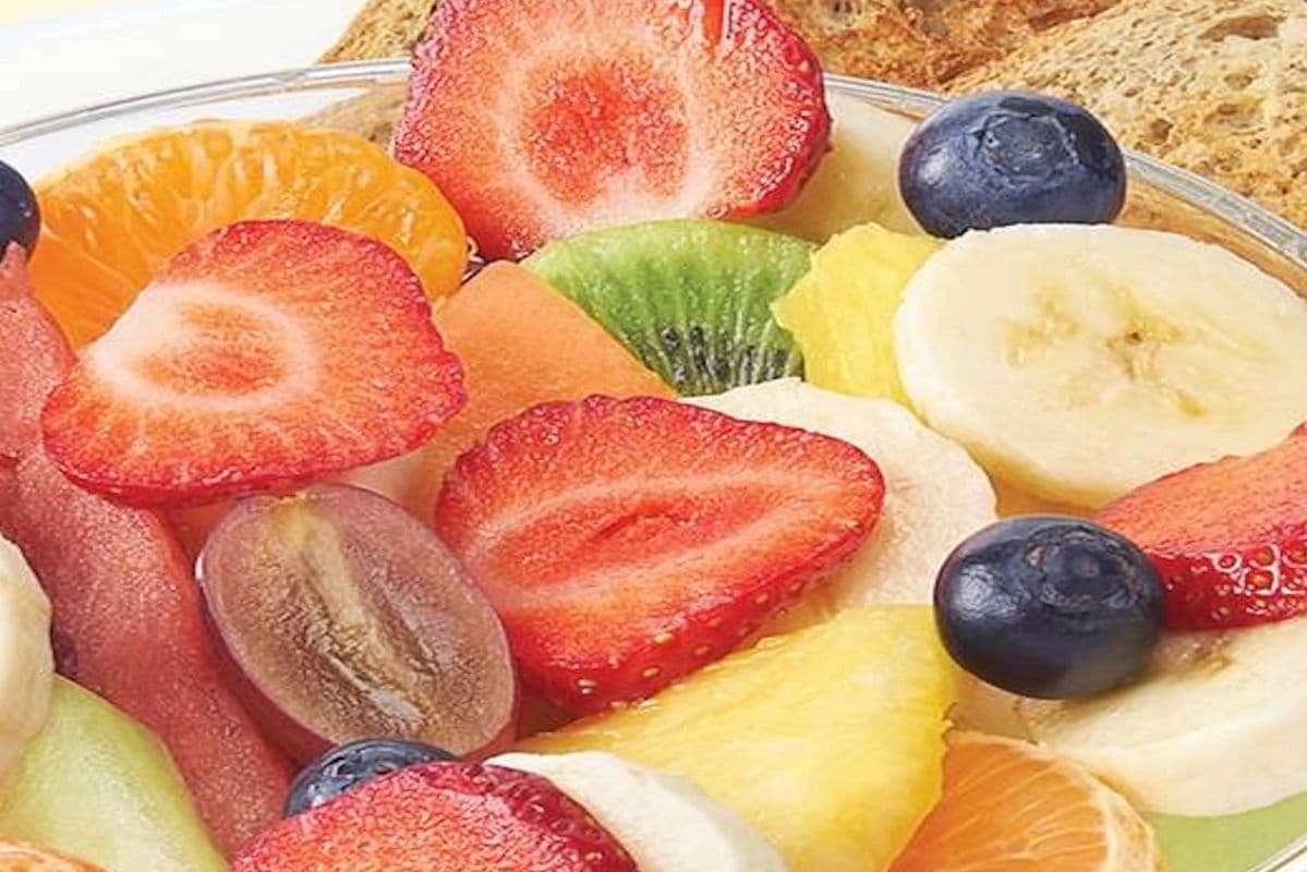 Large bowl of fresh fruit with toast