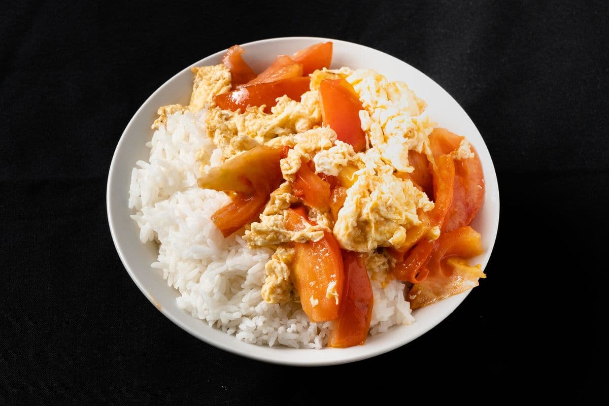 Scrambled Eggs with Tomatoes Over Rice Bowl