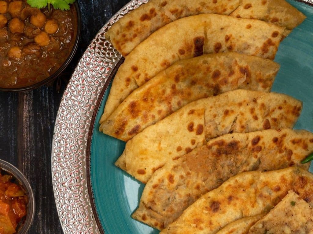 Amritsari Tava Kulcha with Chana, Raita & Dal Makhni