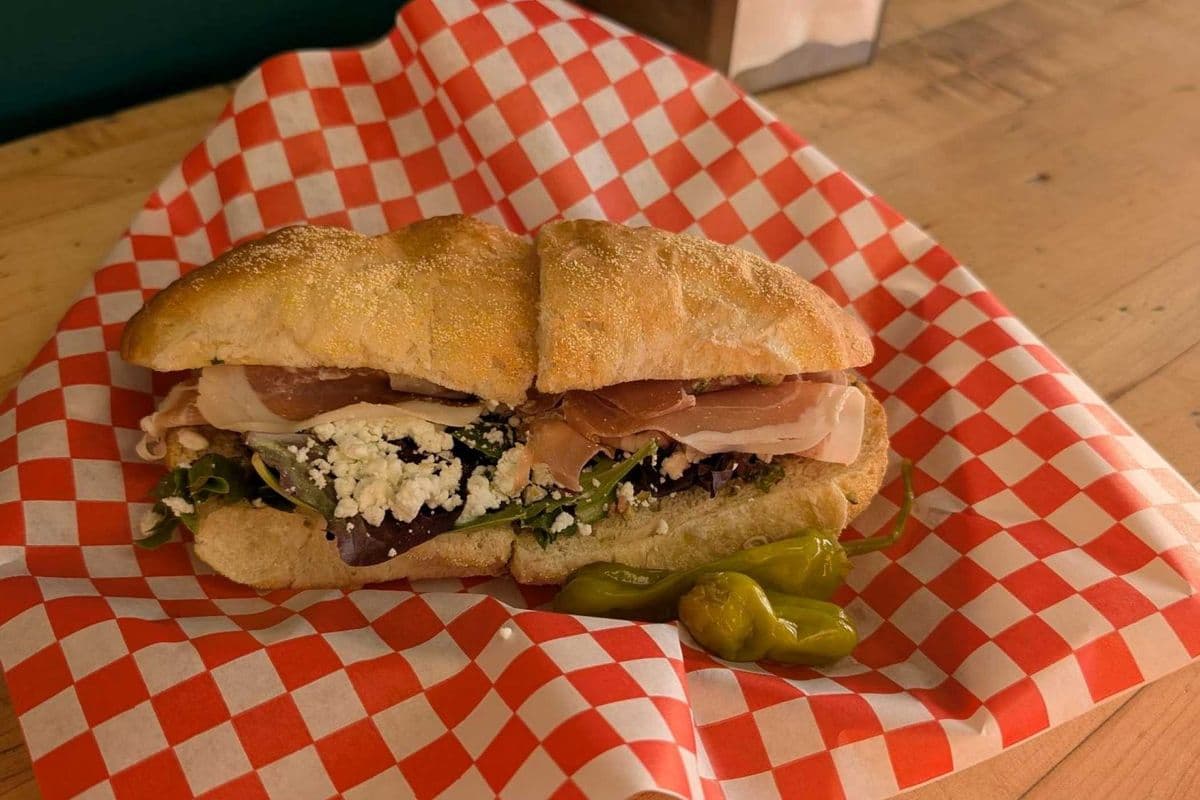 Proscuitto. goat cheese, olives, on a bun