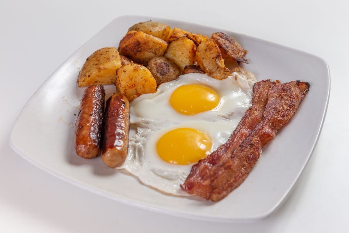 Classic slam, 2 Eggs Any Style, Bacon, Sausage, Home Fries or Grits and fruits